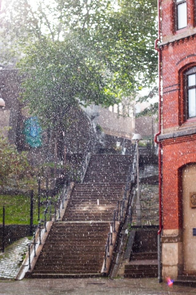 rain falling in the city on the stairs and on buildings